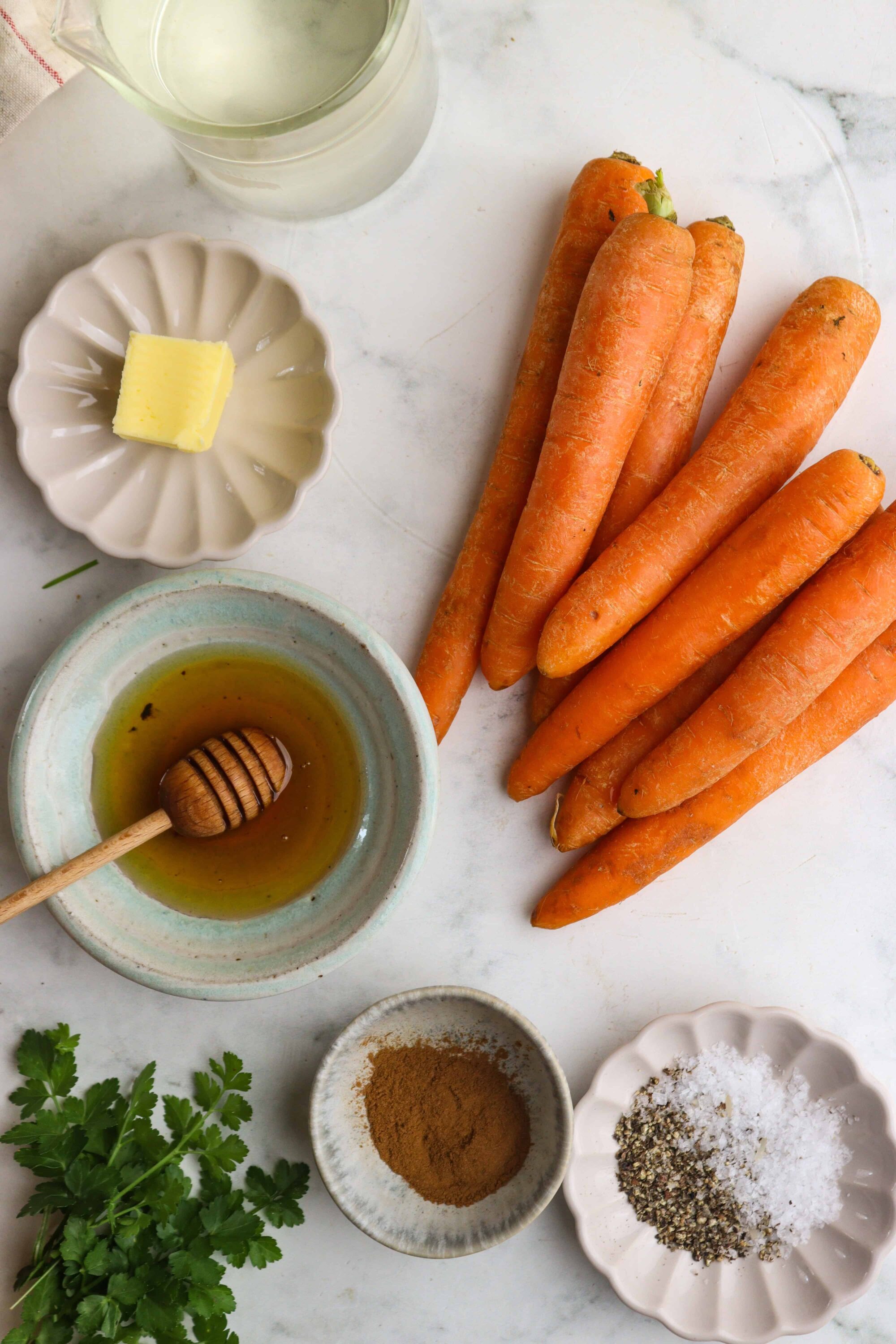 Fresh organic carrots with herbs and spices for homemade carrot soup recipe.
