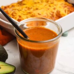 Creamy tomato soup with a cheesy baked casserole in the background. Perfect comfort food for cozy meals.