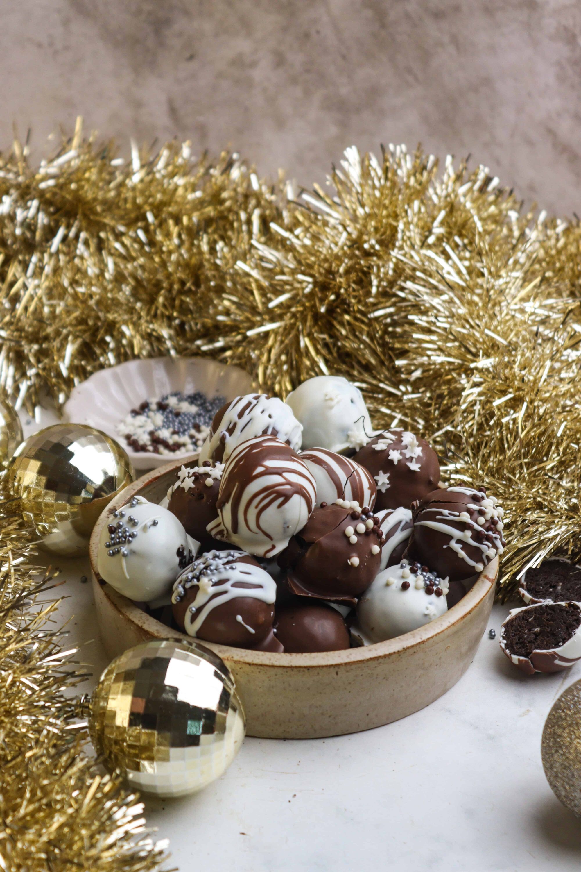 Decadent chocolate truffles with holiday sprinkles in a rustic bowl, perfect for Christmas desserts and festive treats.