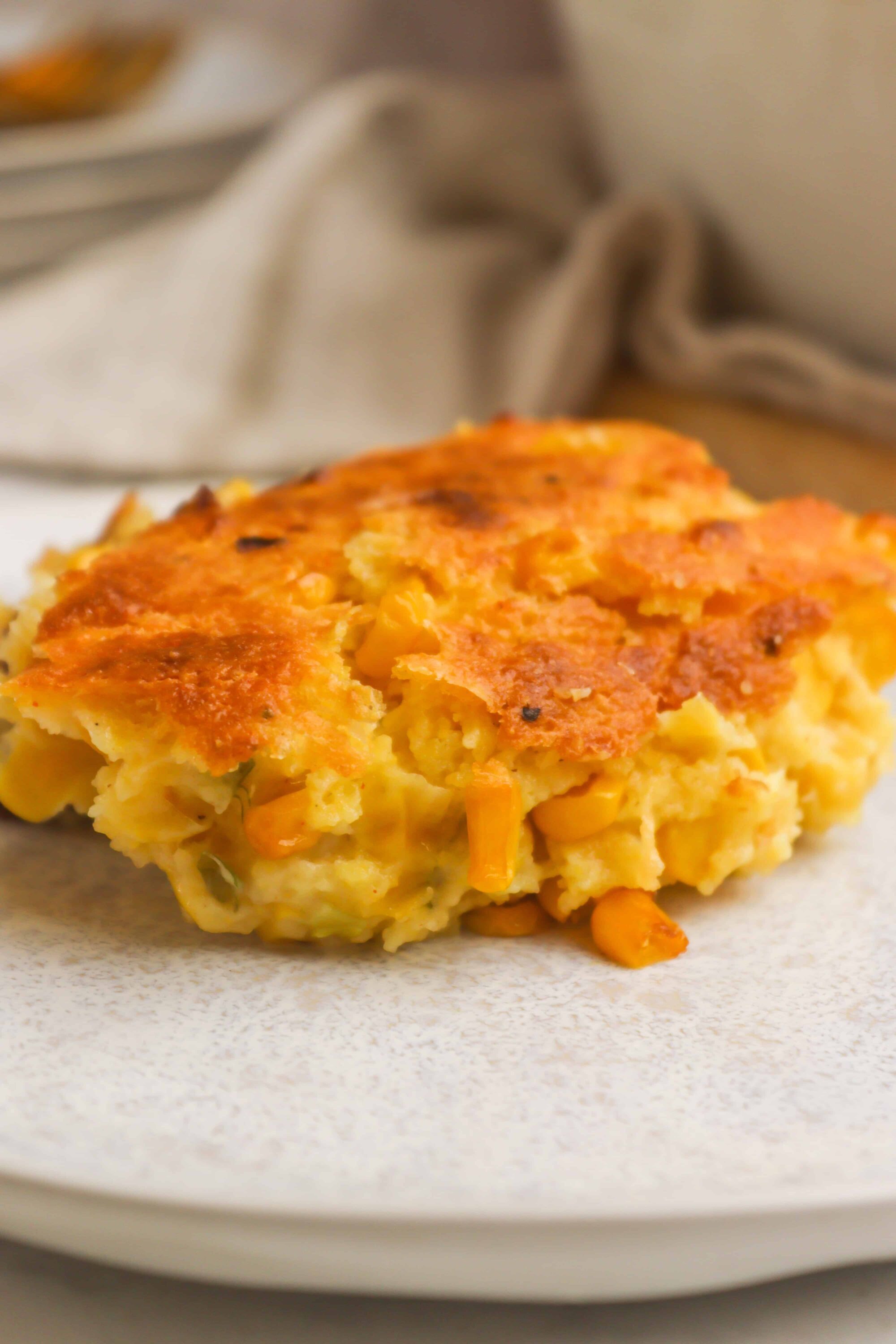 Cornbread casserole with corn and a golden crust, perfect for comforting home-cooked meals.