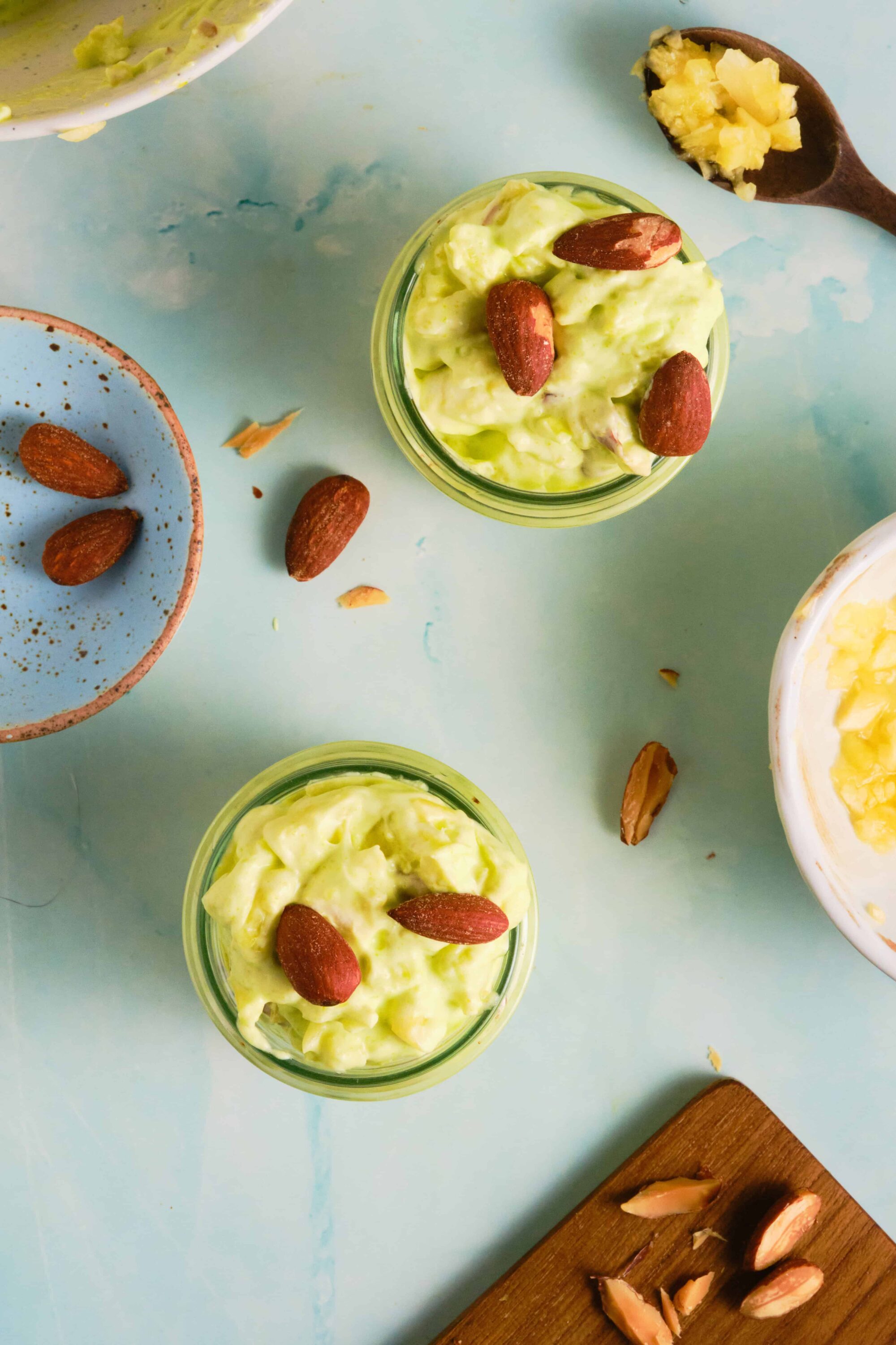 Creamy avocado chicken salad with almonds and fresh herbs, served in glass jars. Perfect for sandwiches or light meals.
