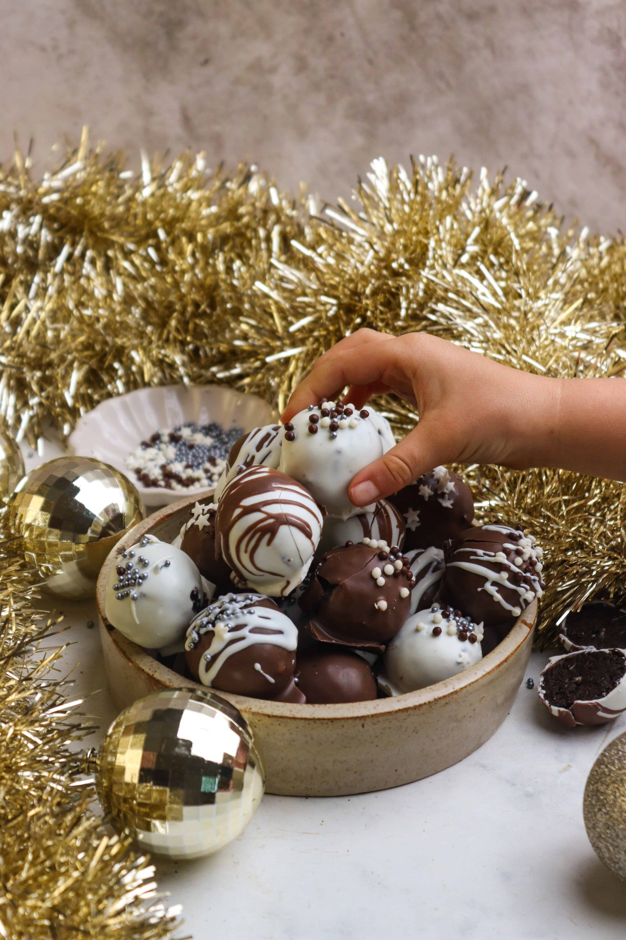 Decorated holiday chocolate truffles in a festive setting, perfect for Christmas desserts and gift-giving.