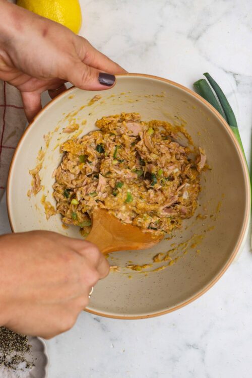 Savory chicken and vegetable filling in mixing bowl for baked dish or pie, creamy and flavorful, close-up shot.