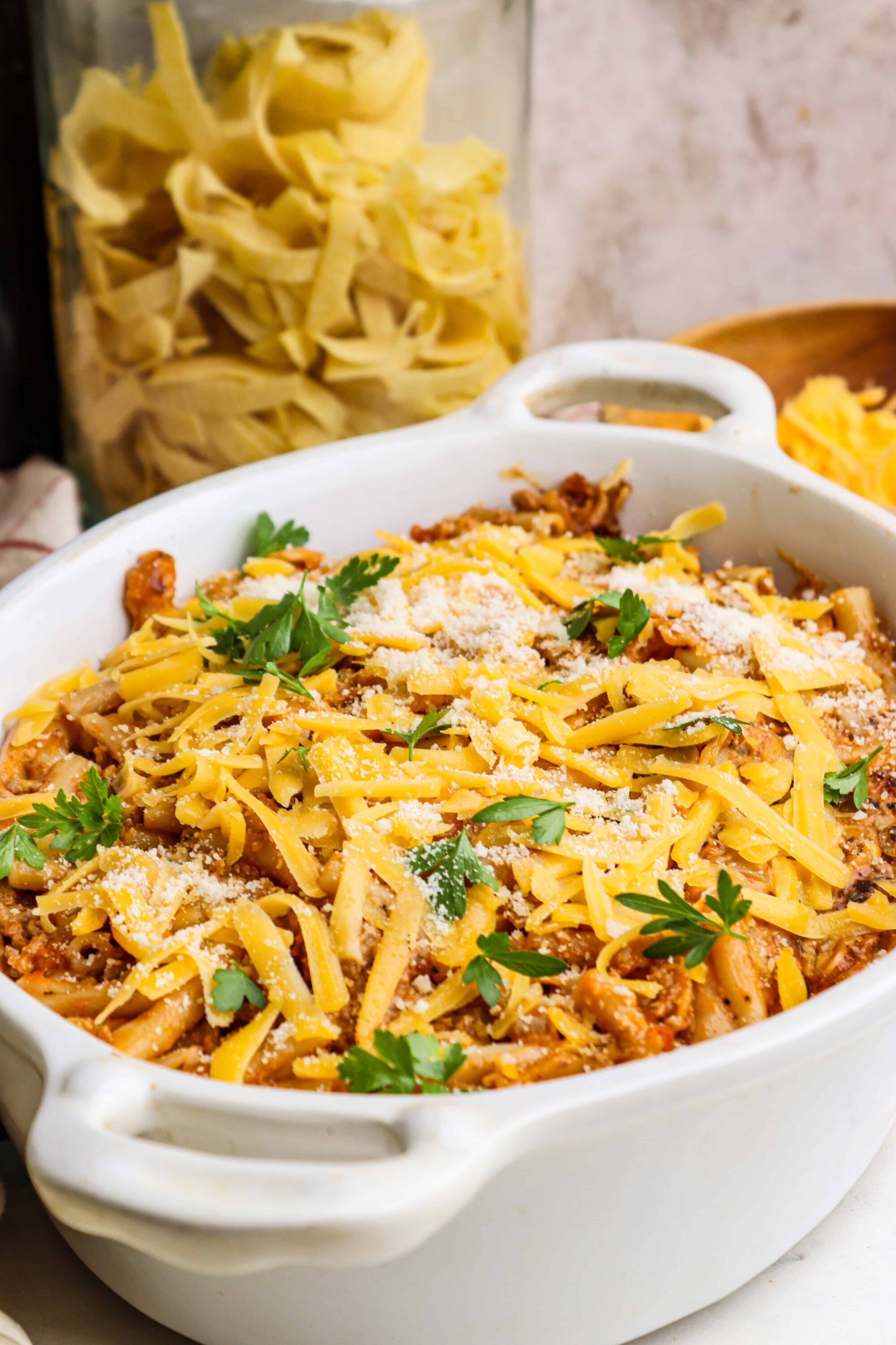 Creamy Baked Ziti with ricotta and mozzarella cheese in a white baking dish.