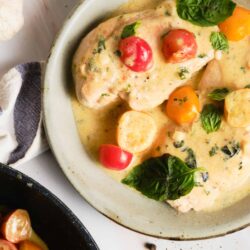 Creamy chicken with cherry tomatoes and fresh basil in a savory sauce.