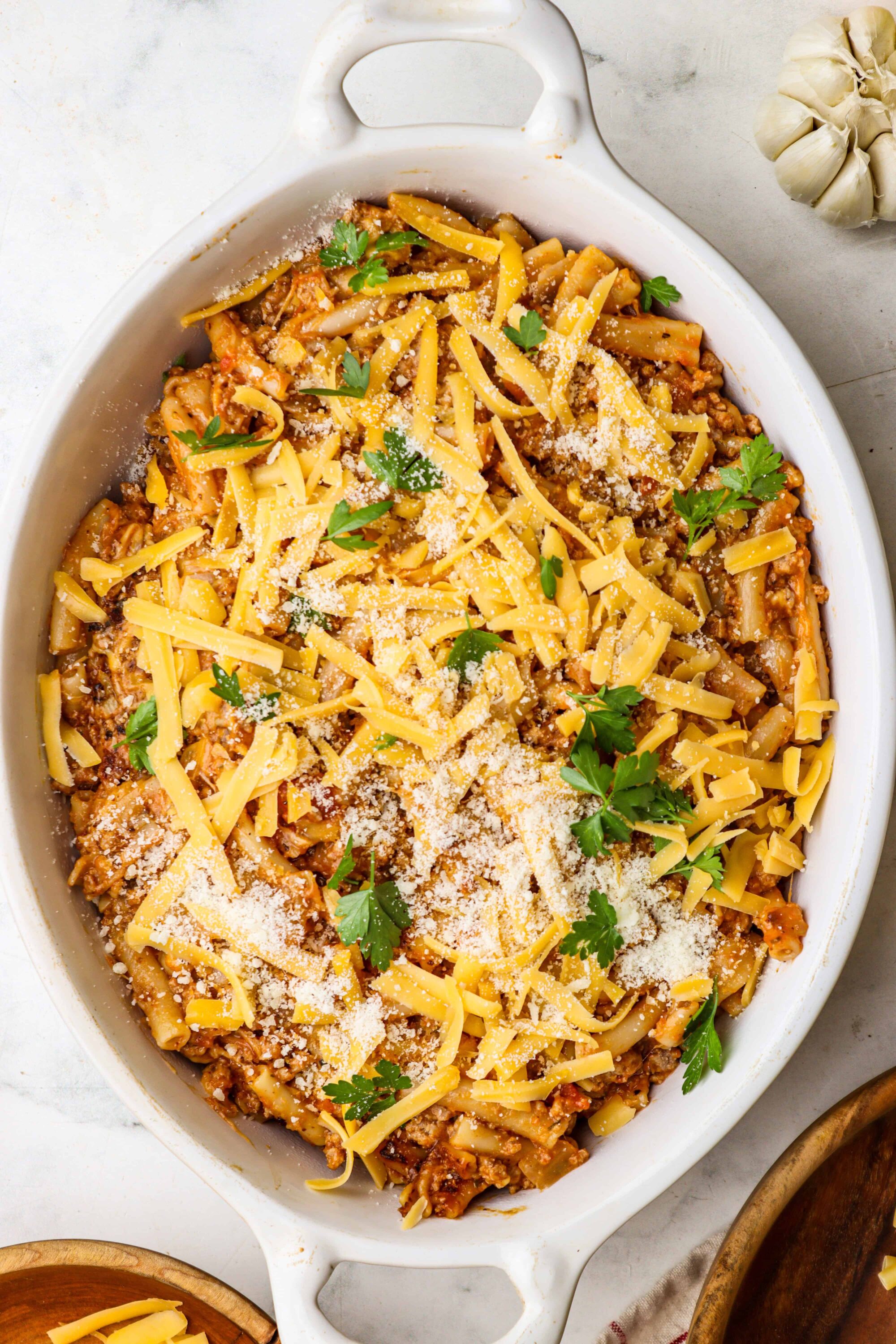 Cheesy baked pasta casserole with ground beef and fresh parsley.