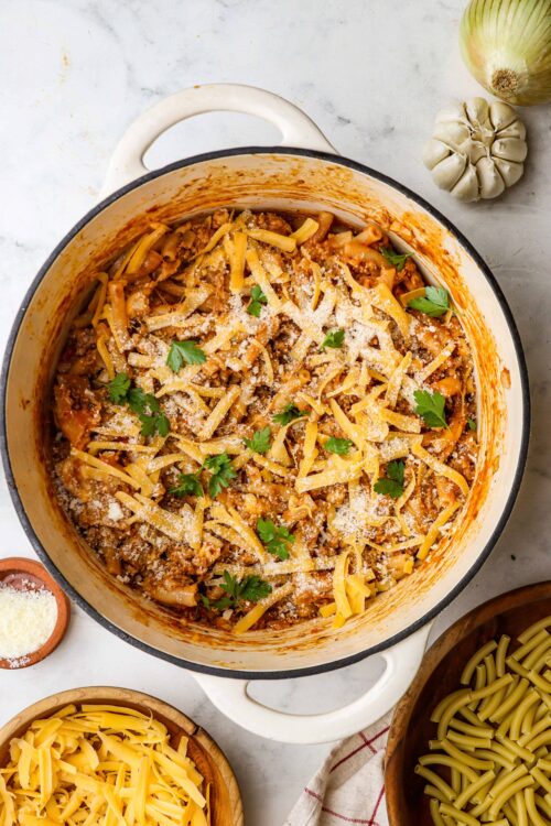 Creamy baked ziti pasta casserole with ground beef, cheese, and fresh parsley. Perfect comfort food recipe.