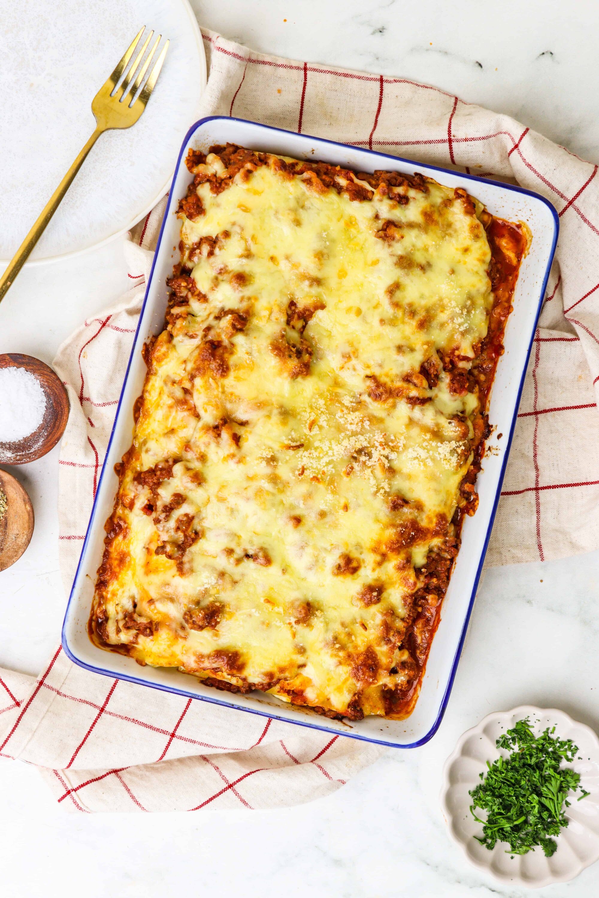 Cheeseburger pasta casserole baking dish with melted cheese and savory meat sauce.