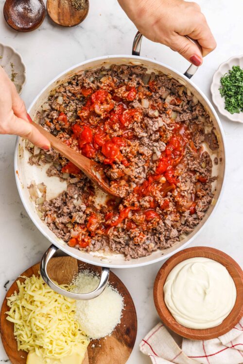 Savory ground beef and tomato sauce cooking in a skillet, wholesome comfort food.