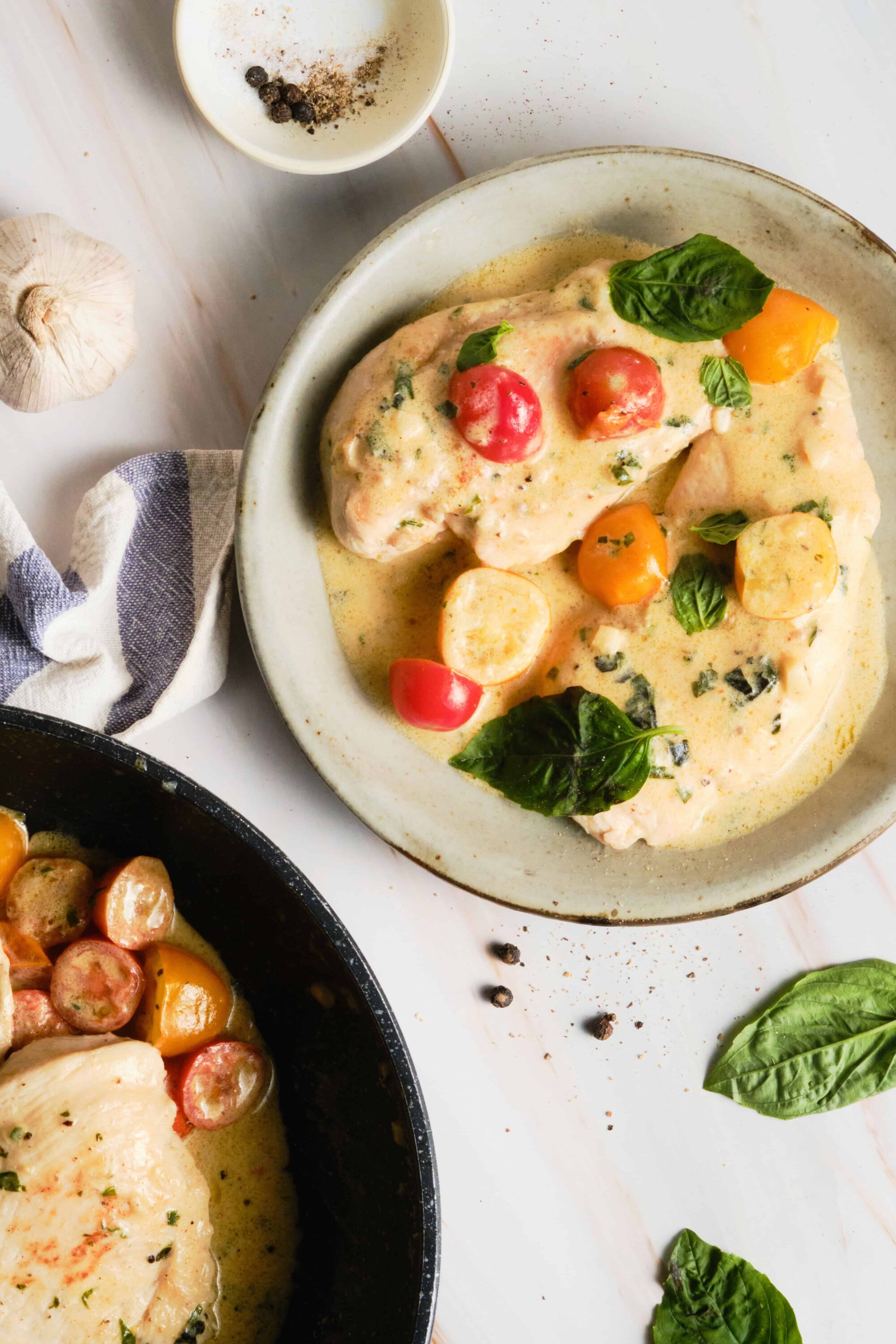 Succulent chicken with creamy herb sauce and cherry tomatoes, garnished with fresh basil. Perfect for easy dinner recipes.