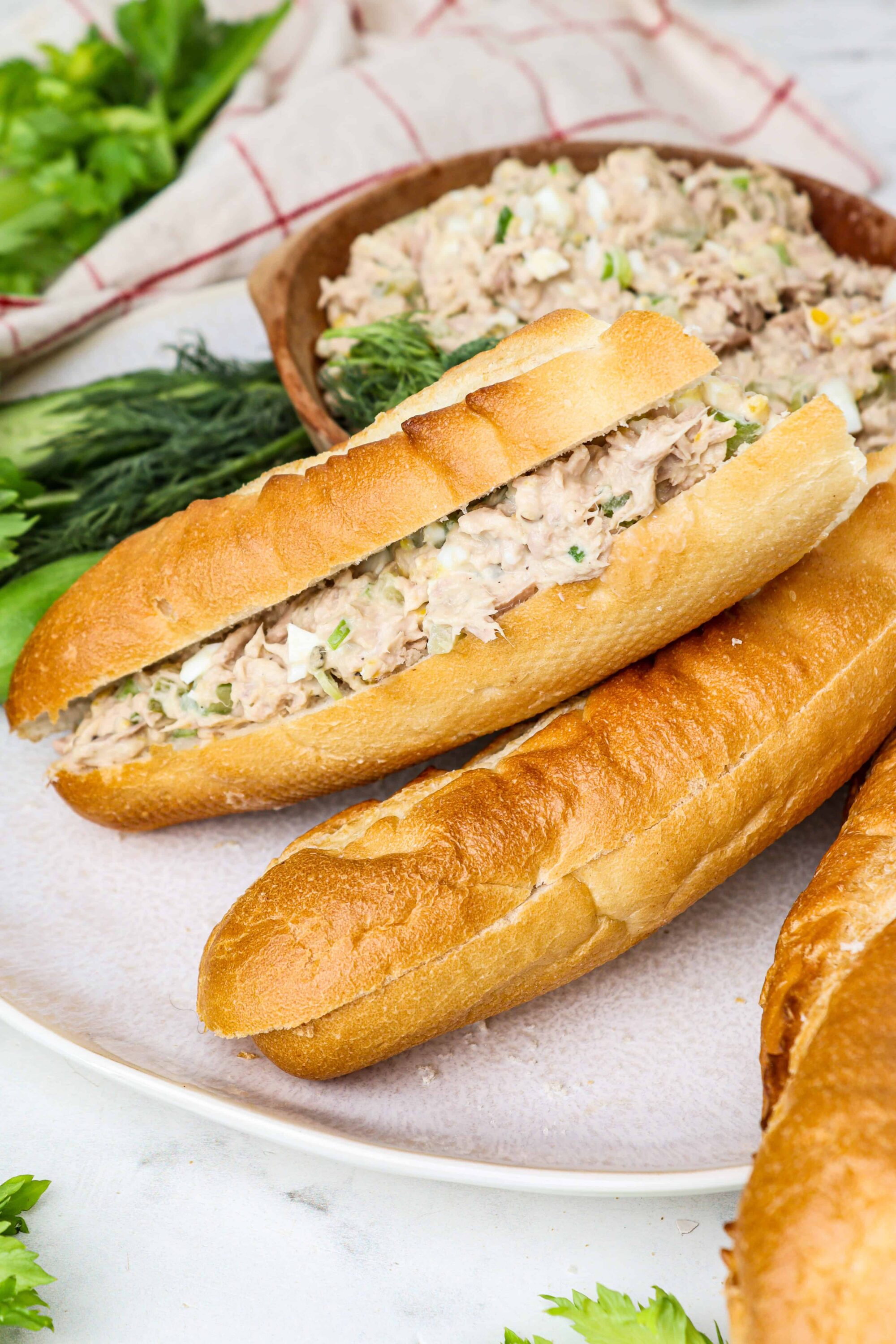 Creamy tuna salad sandwich on a French bread baguette.