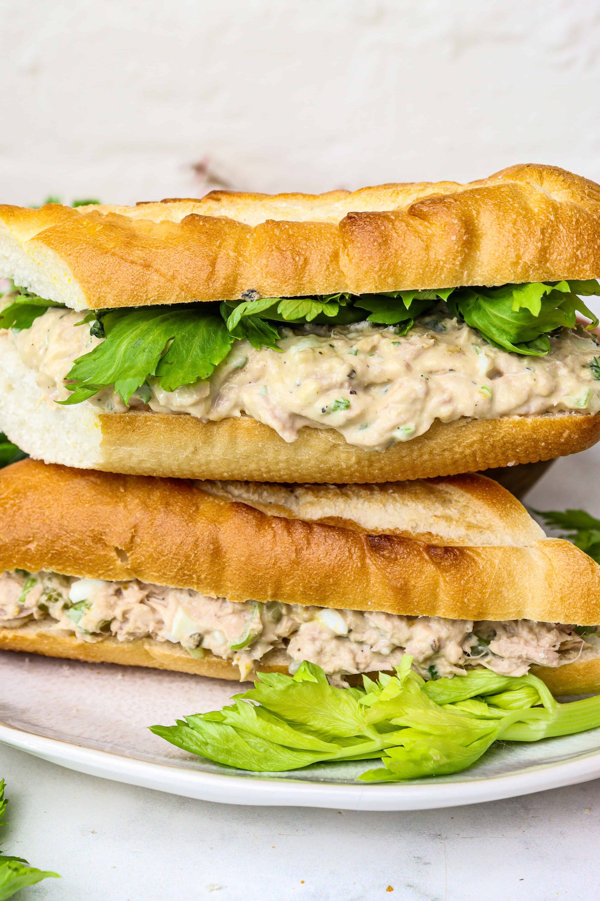 Creamy chicken salad sandwich on toasted baguette with fresh greens, ideal for lunch or picnic.