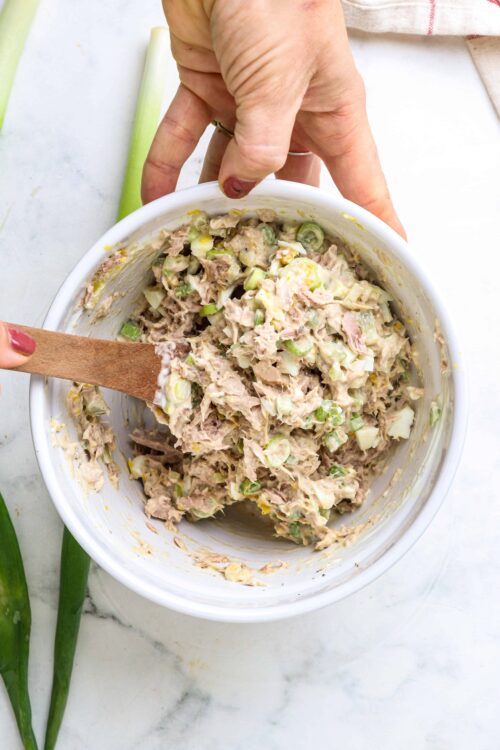 Creamy tuna salad with celery and mayonnaise in a white bowl, ready to serve.