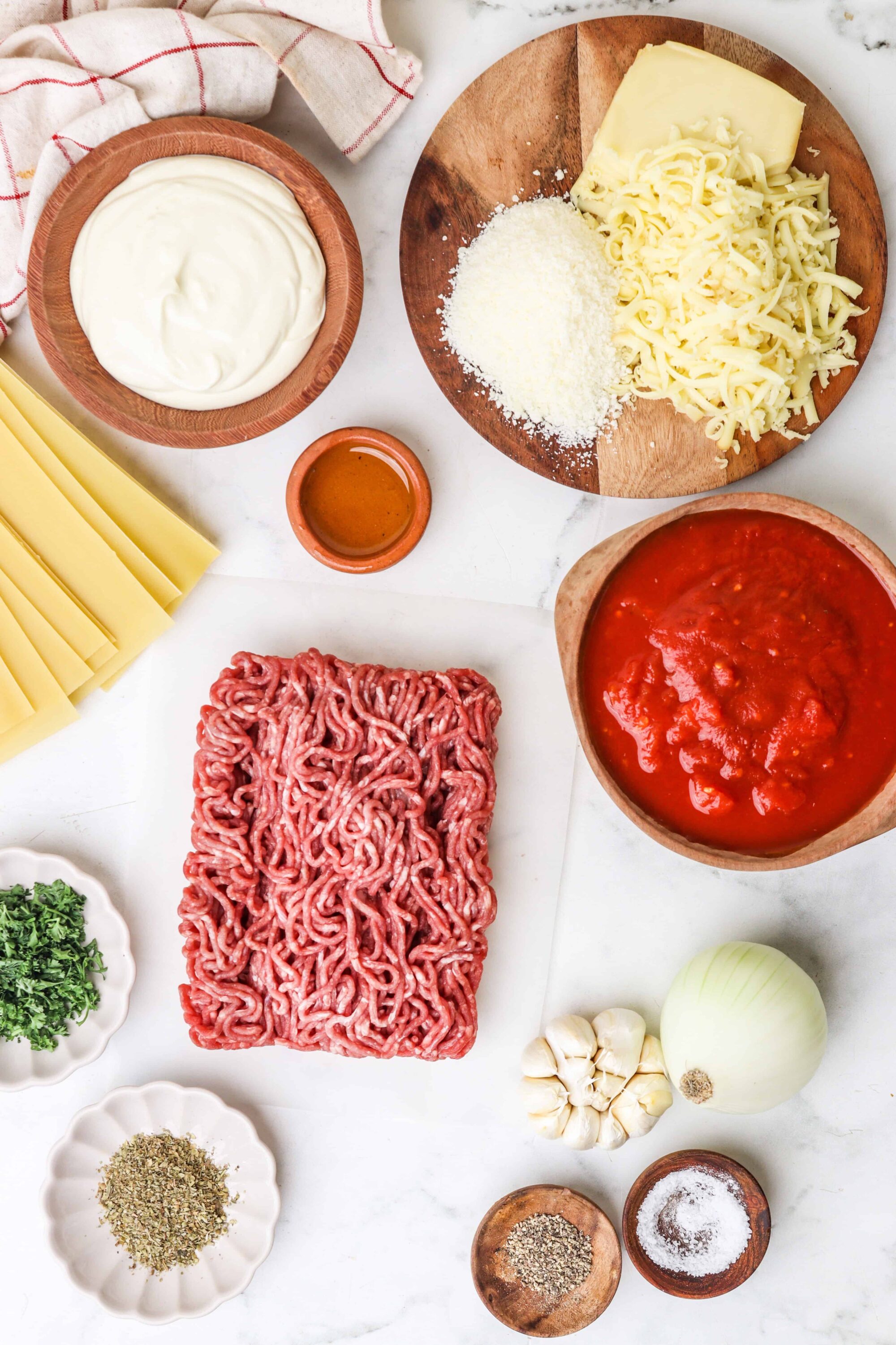 Ground beef, cheese, and ingredients for baked ziti pasta dish.