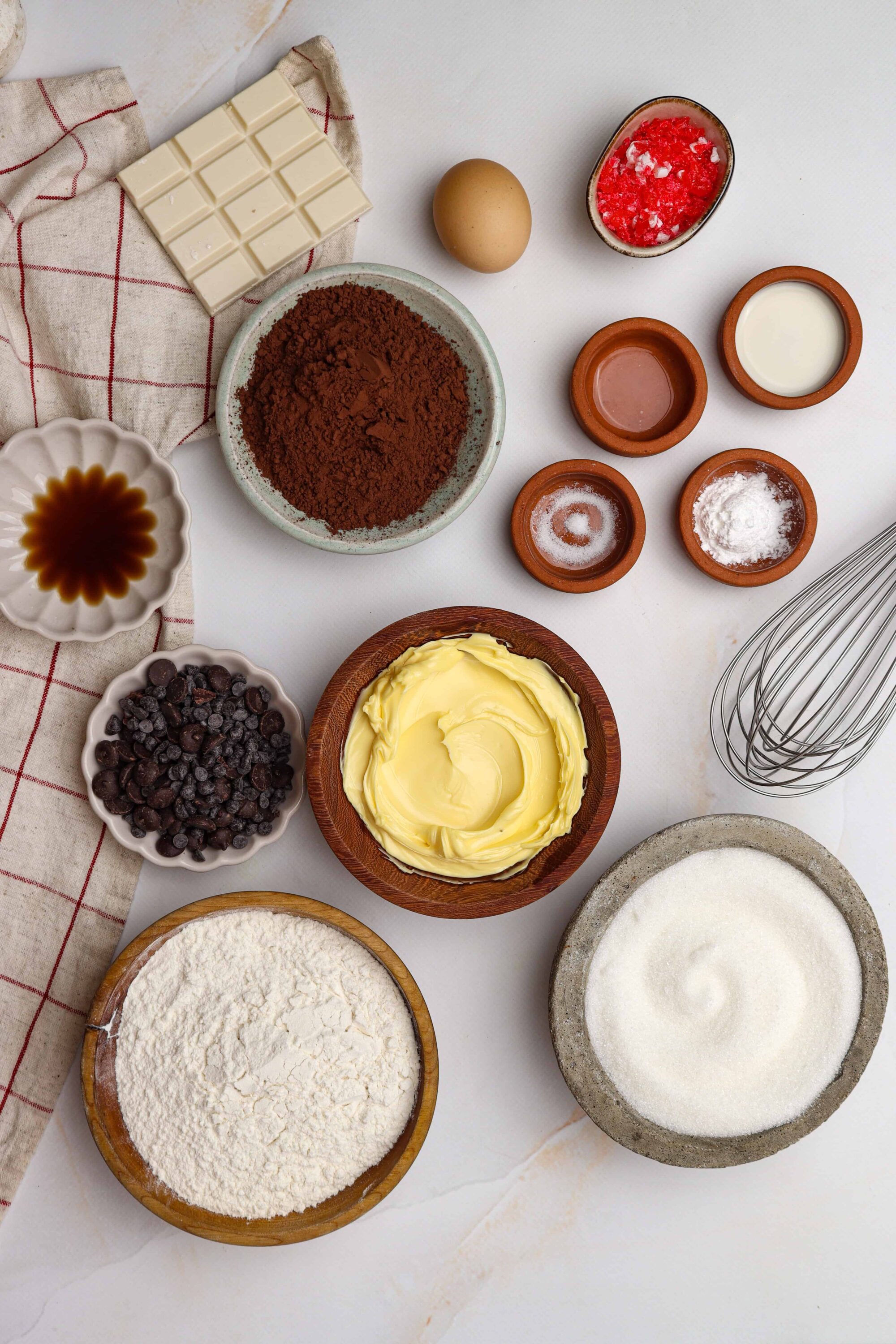 Creamy butter, chocolate, eggs, and baking ingredients for chocolate cake preparation.