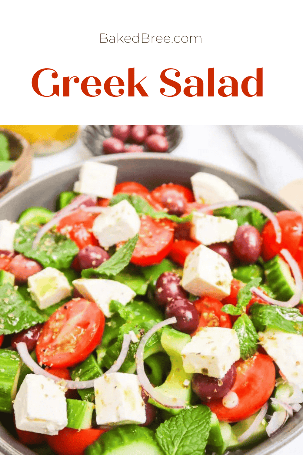 Fresh Greek salad with feta, cherry tomatoes, cucumbers, and mint in a bowl.