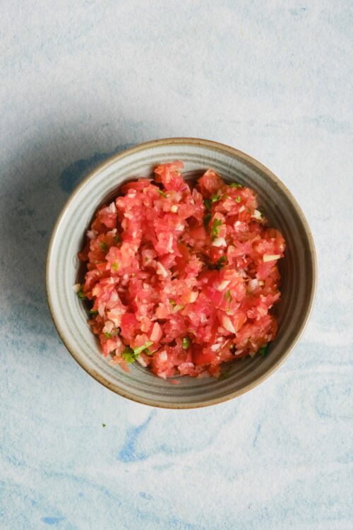 Diced tomato salsa in ceramic bowl for Mexican or Mediterranean recipes.