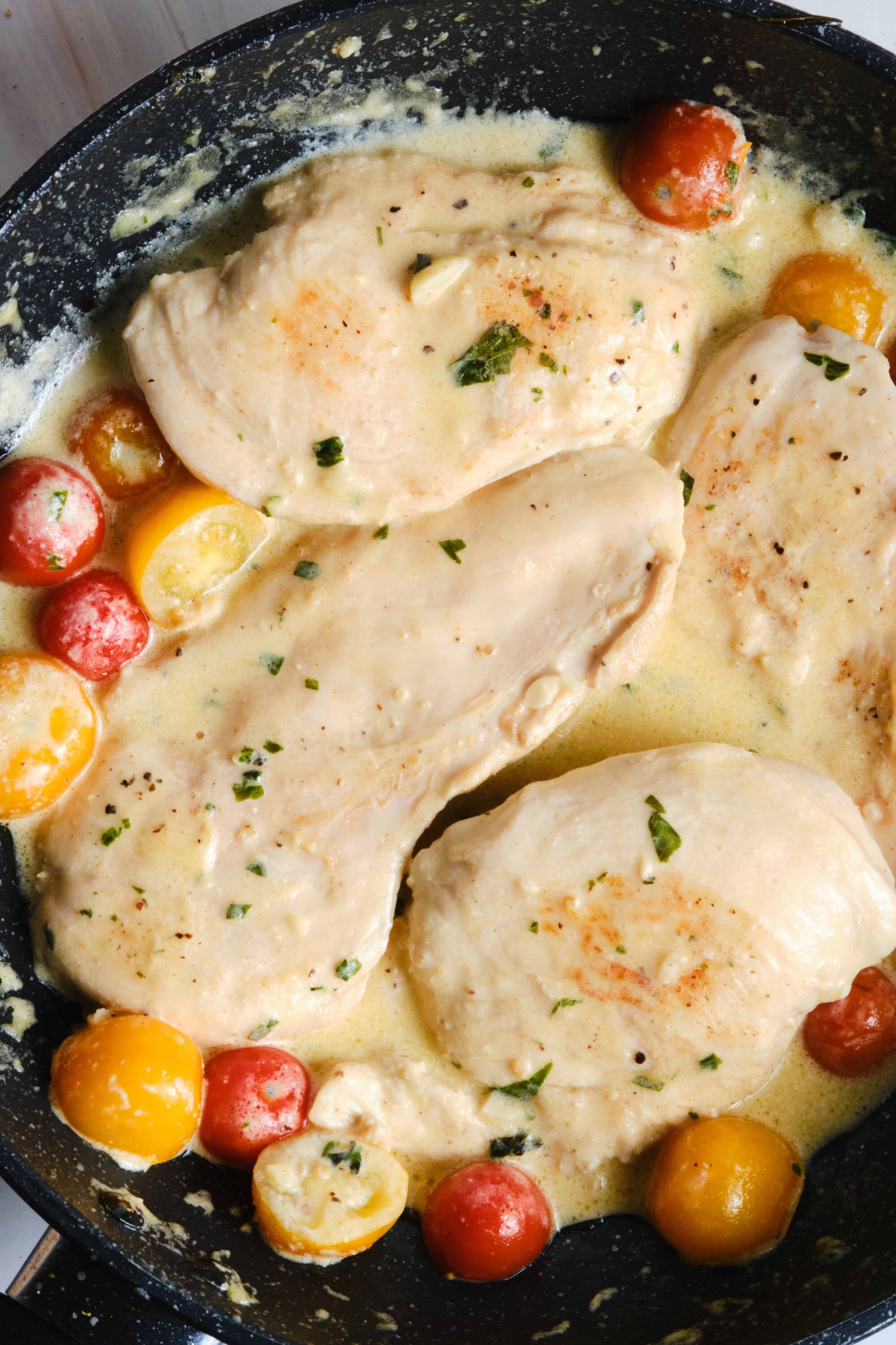 Succulent chicken breasts in creamy herb sauce with cherry tomatoes, homemade, easy chicken dinner recipe.