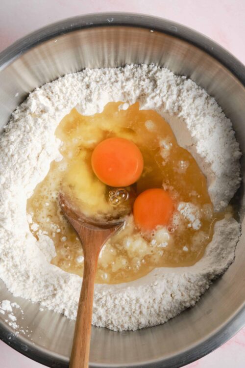 Flour and eggs mixture in a mixing bowl for baking recipes.