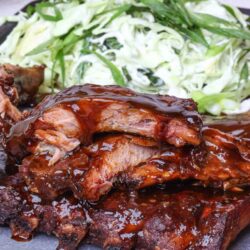 Juicy barbecue ribs with rich sauce served with fresh coleslaw salad. Perfect for summer barbecues and family dinners.