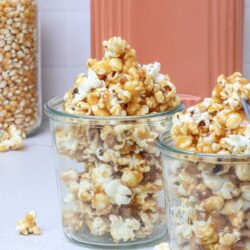 Buttery caramel popcorn in glass jars.