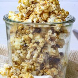 Buttered popcorn with caramel and sea salt in a glass jar.