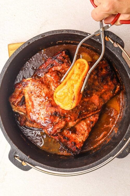 Slow cooker beef roast in rich gravy with vegetables and herbs.