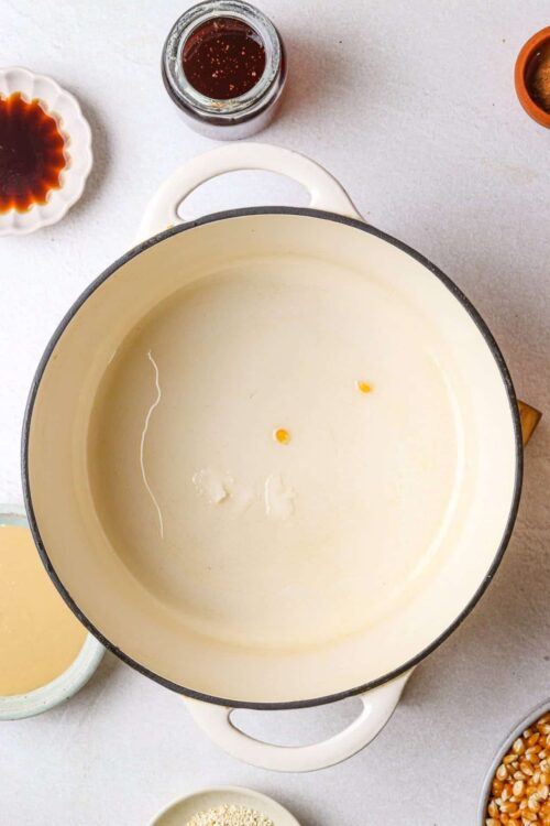 Creamy vegan cheese sauce in a cast-iron skillet ready for baking or cooking.