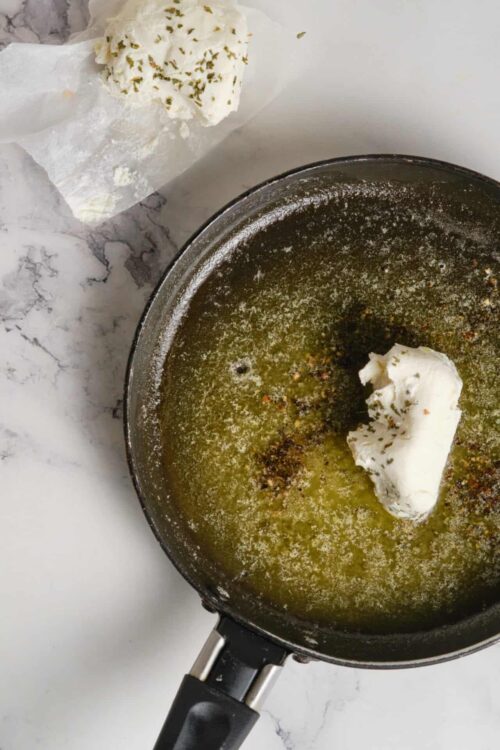 Buttered herb compound butter melting in a skillet for recipes.