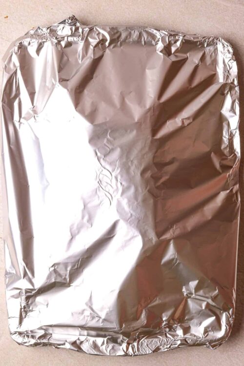 Aluminum foil wrapping dish ready for baking or storage.