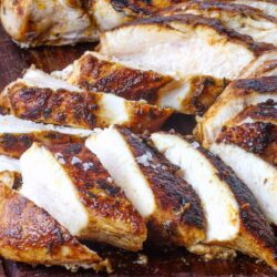 Juicy roasted chicken breast with crispy skin and savory seasoning.