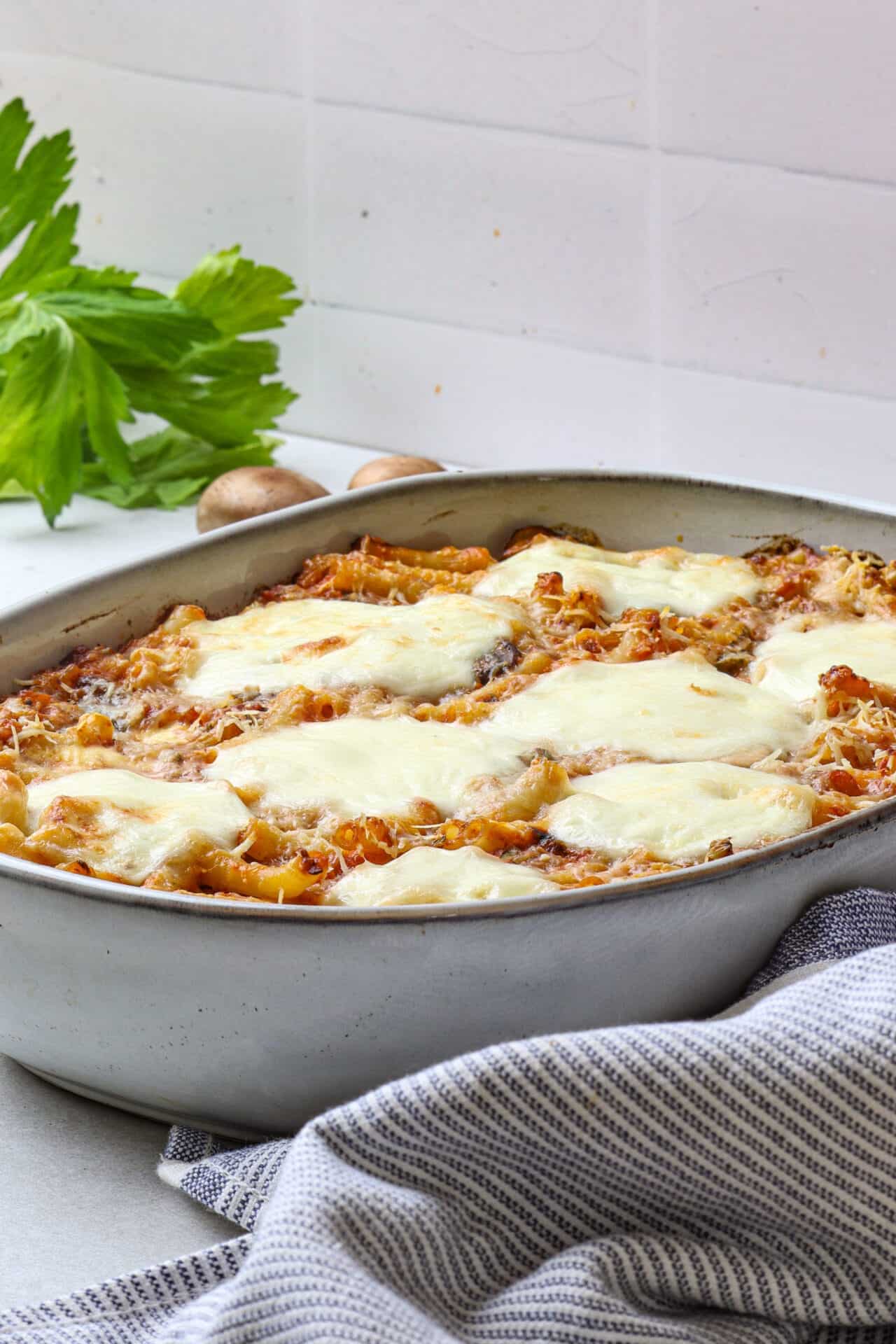 Creamy homemade baked pasta with melted cheese and savory sauce in an oval baking dish.