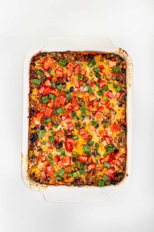 Savory baked casserole with melted cheese and fresh diced tomatoes and green onions.