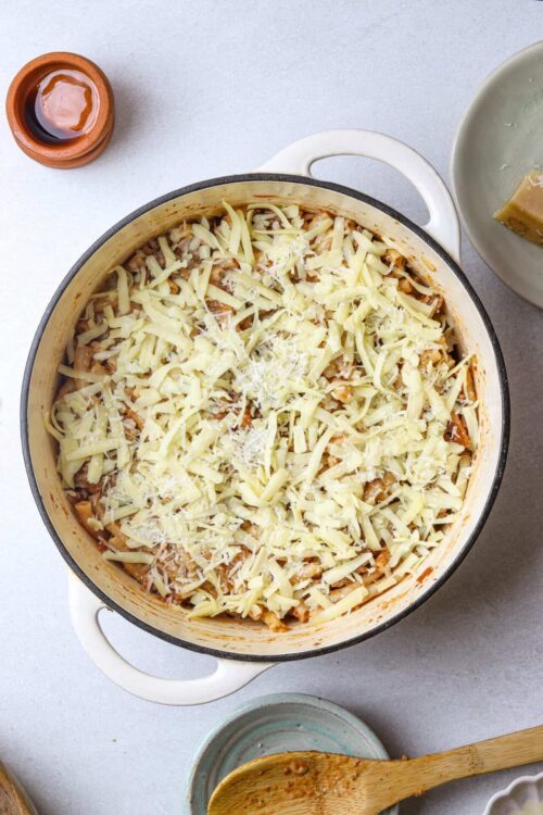 Creamy baked pasta casserole topped with shredded cheese and Parmesan.