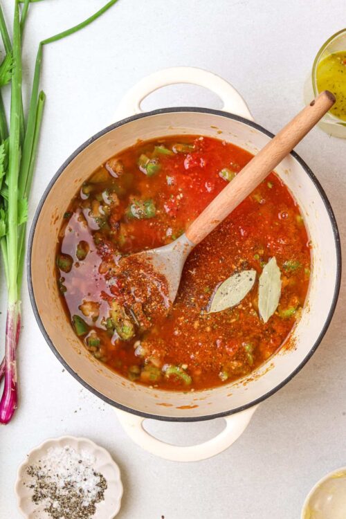 Rich homemade tomato soup simmering with herbs and vegetables, perfect for comforting meals.
