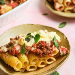 Creamy baked ziti with ricotta and fresh basil in a rustic bowl. Perfect comfort food for family dinners or gatherings.