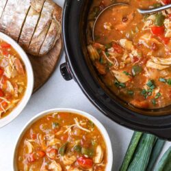 Creamy slow cooker chicken and vegetable soup with tender chicken, fresh vegetables, and herbs in a savory broth.