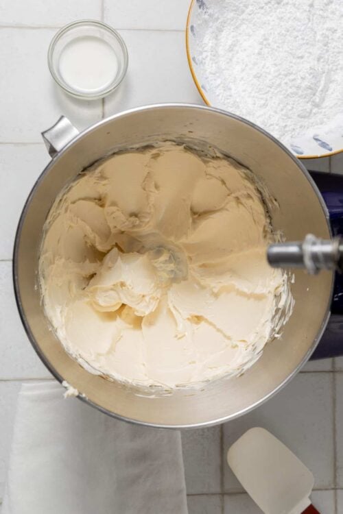 Cream butter in a mixer for baking recipes, starting the process of making cake batter or frosting.