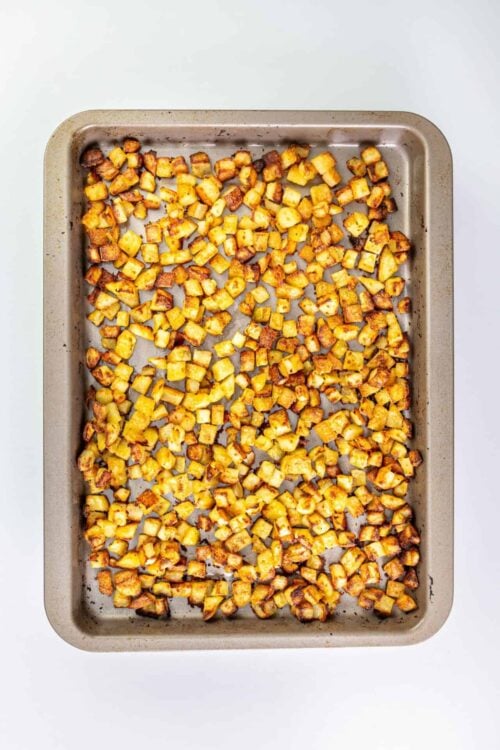 Crispy roasted breakfast potatoes on baking sheet.