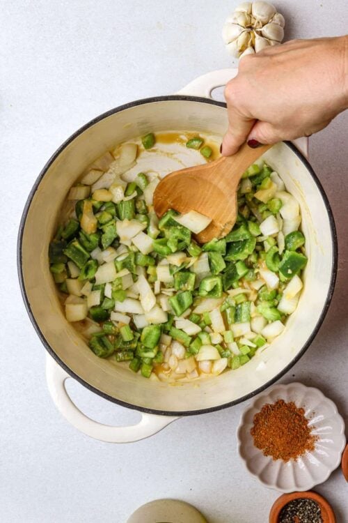 Chopped green onions and garlic simmering in a creamy skillet for recipes.