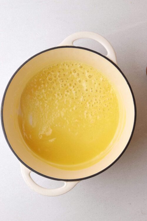 Creamy melted butter in a yellow Dutch oven, perfect for baking and cooking.