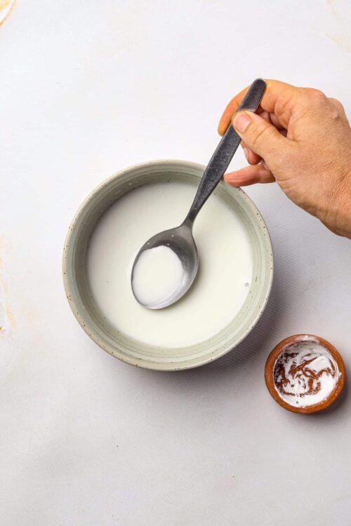 Cream in bowl for homemade baked goods, dairy-based ingredient for baking recipes, milk used in baking and cooking.