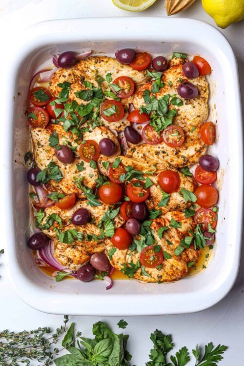Juicy baked chicken breasts topped with cherry tomatoes, olives, and fresh herbs. Perfect for a flavorful and healthy dinner.