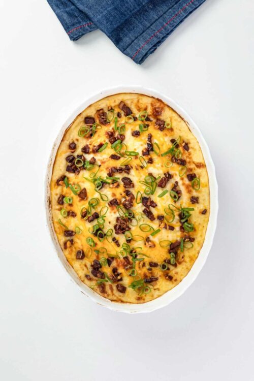 Cheesy potato casserole with bacon and green onions, baked to golden perfection.