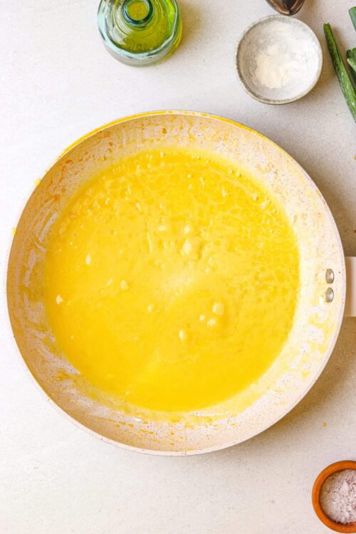 Fluffy yellow pancake batter in a mixing bowl ready to cook.