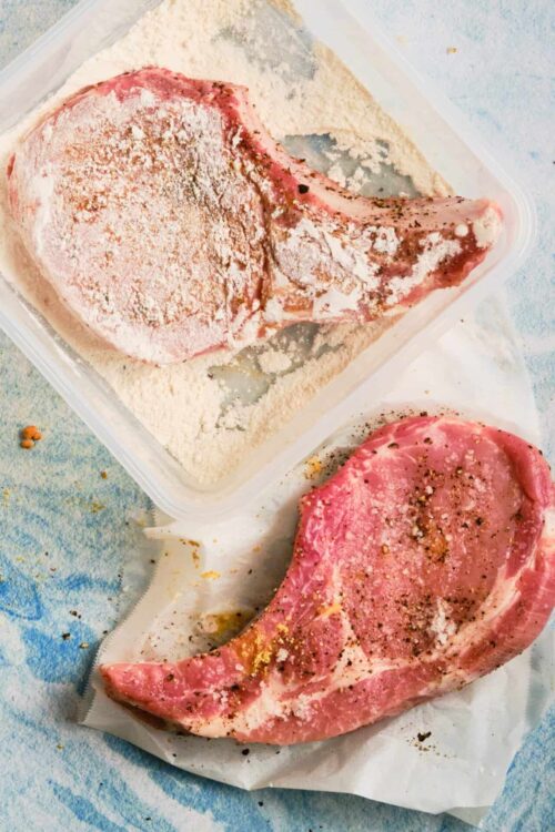 Juicy raw pork chops seasoned with salt, pepper, and spices, ready for baking or grilling.