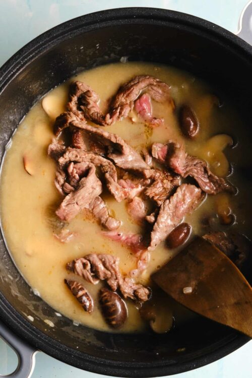 Slow cooker beef stew with tender beef strips, mushrooms, and flavorful broth. Perfect comfort food recipe for cozy dinners.