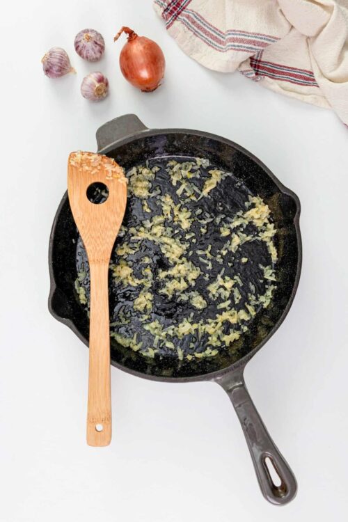Sautéed onions and garlic in a cast iron skillet.