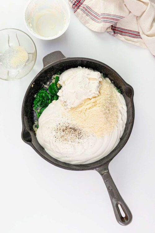 Cream cheese and spinach mixture for baked dishes in a skillet.