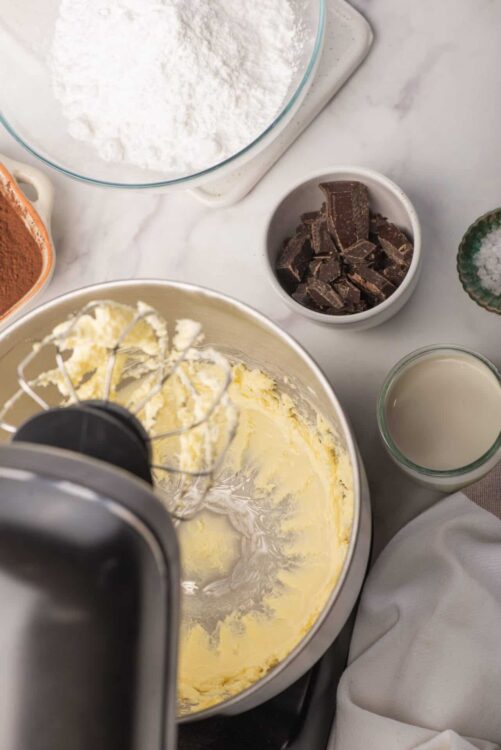 Creamy butter and sugar mixture in stand mixer for baking recipe.